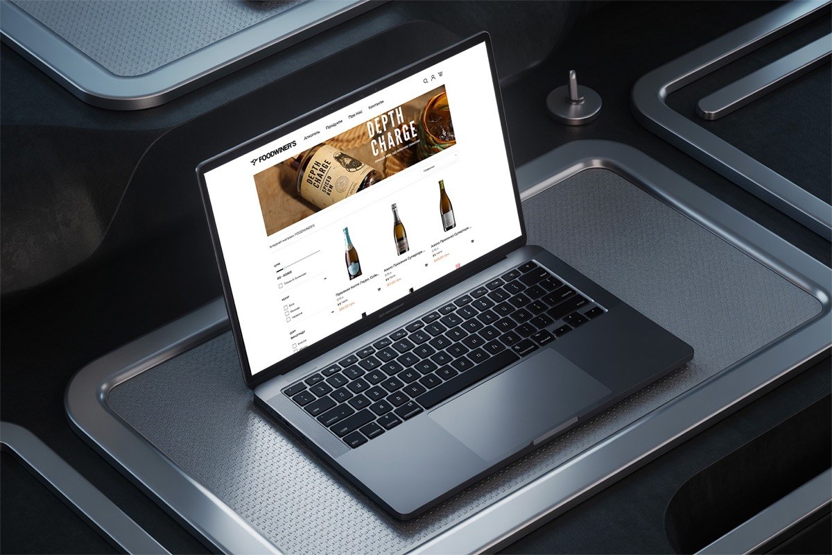 FOODWINER'S online wine store on a laptop, the web storefront whose PHP/MySQL engine also serves the iOS app